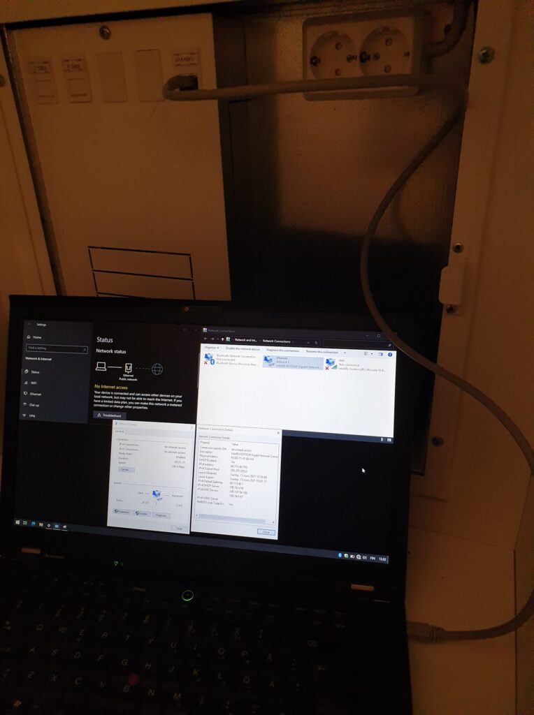 Laptop hooked up to an apartment network distribution cabinet.